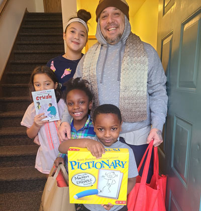 Fernando and his children receive gift bags