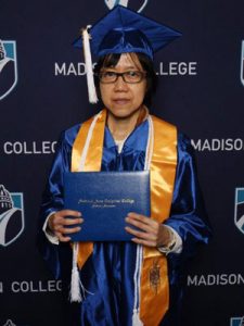 Odyssey alumn Milli Lau in cap and gown