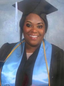 Odyssey alumn Nicole in cap and gown