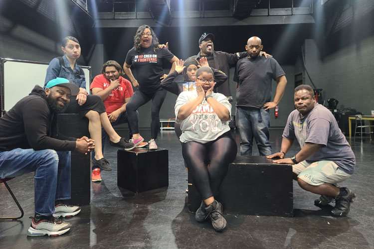 Odyssey theatre class poses on stage