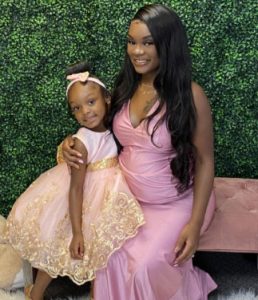 Kayanna with her daughter, both dressed up for an event