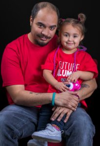 Headshot of Brandyn and his daughter, Brandyn is an Odyssey graduate of the Class of 2022