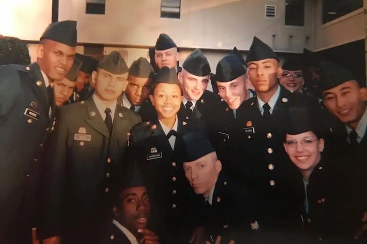 Dominique Christian with her U.S. Army personnel, standing in a group and smiling in uniforms