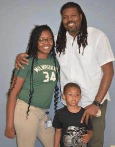 Corey, standing with his daughter and grandson