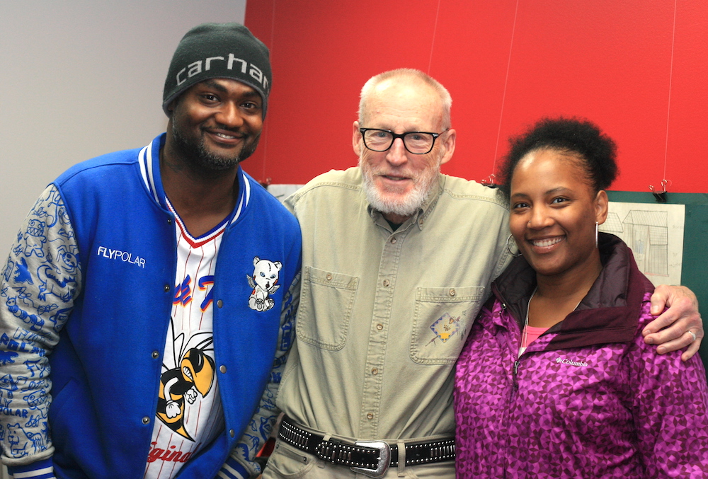 An older man stands with two UW–Madison Odyssey Project students.
