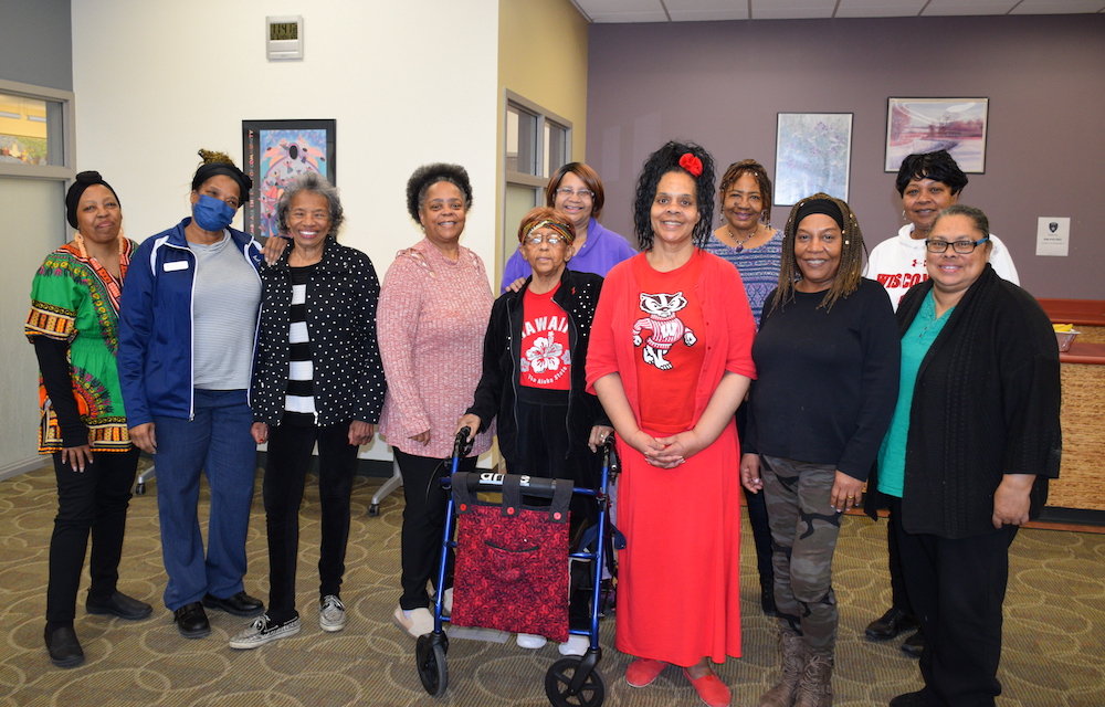 A group of UW–Madison Odyssey Seniors stand with staff, smiling. 