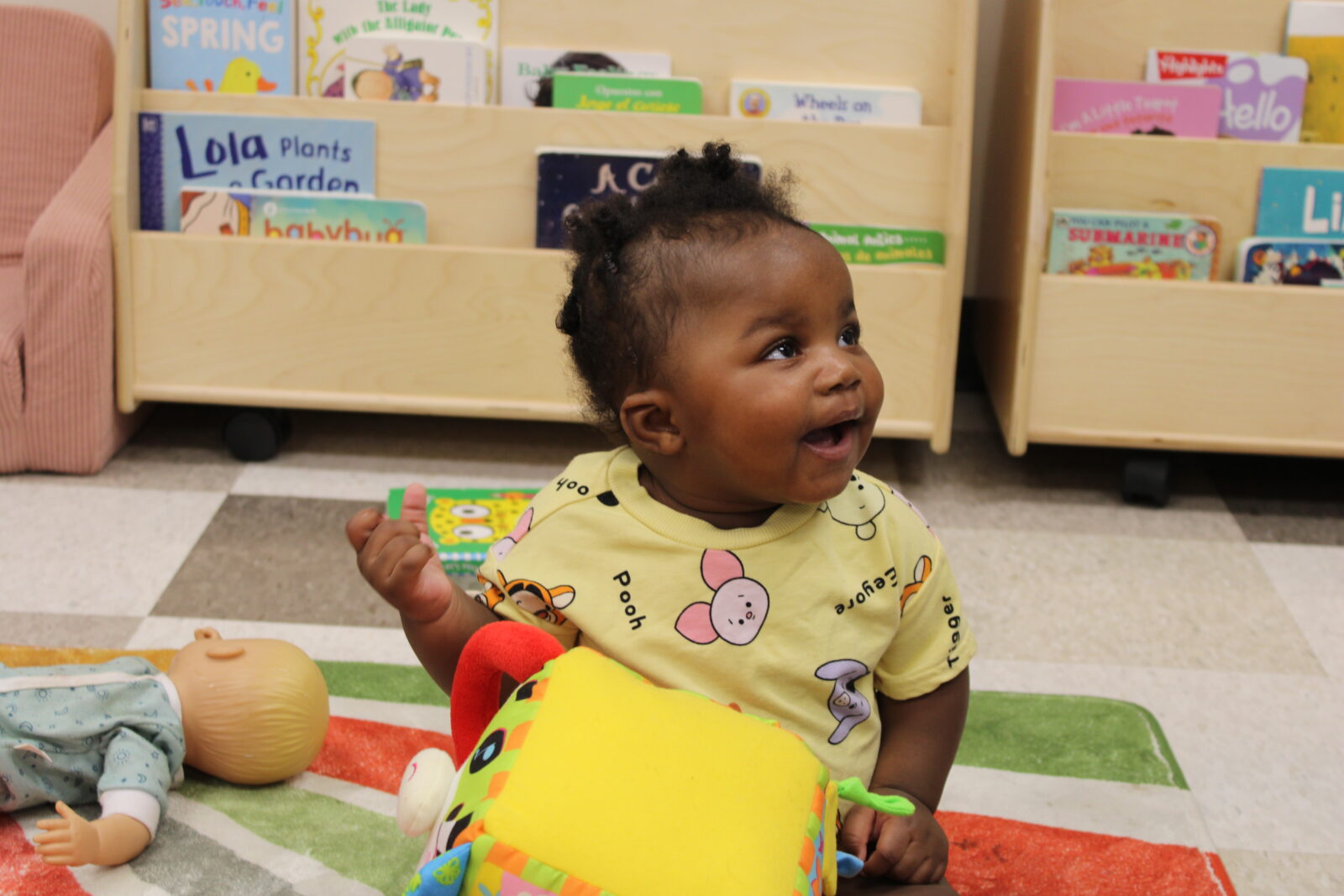 Odyssey Junior baby badger student smiling while playing with a toy