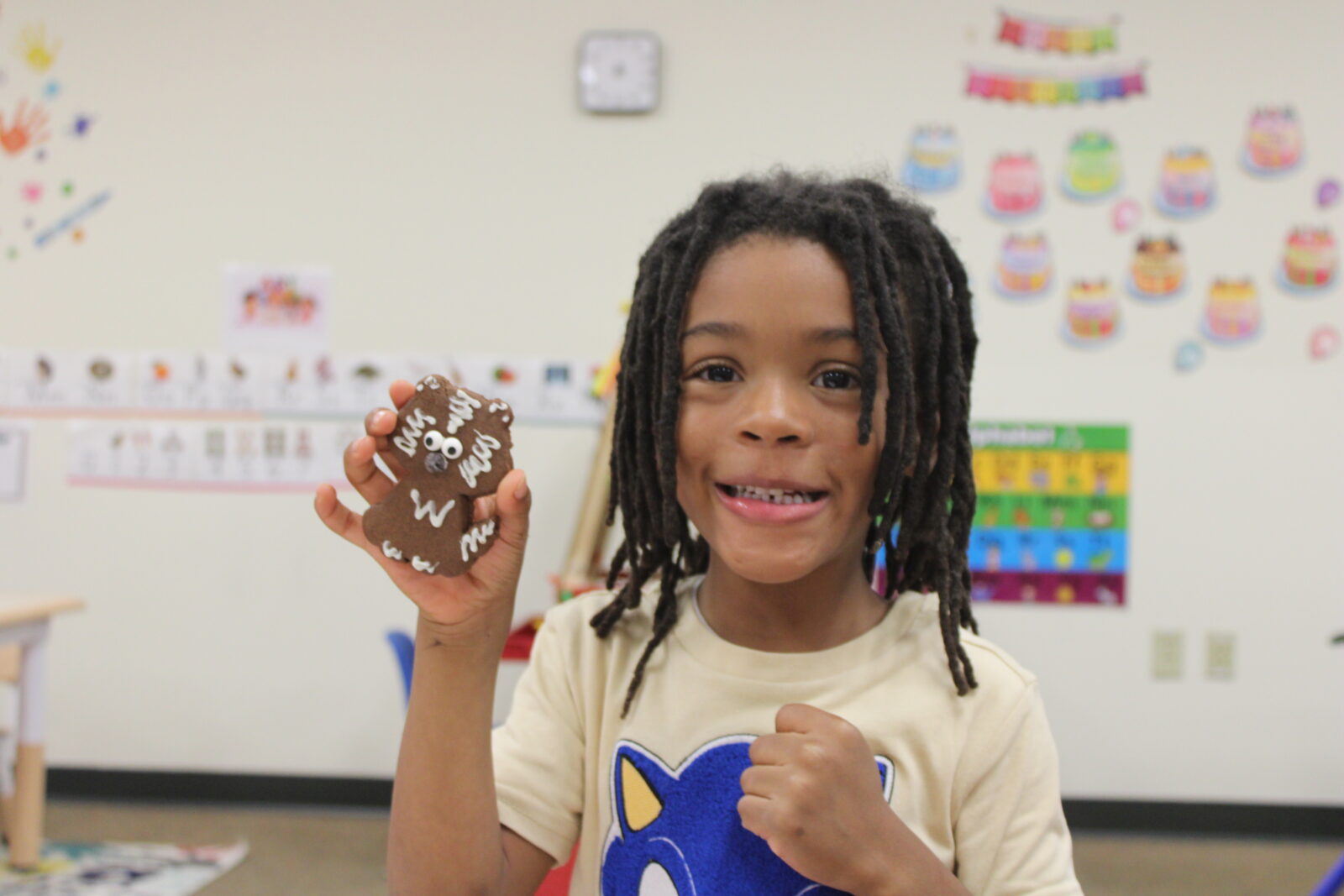 Odyssey Junior student holds a decorated cookie